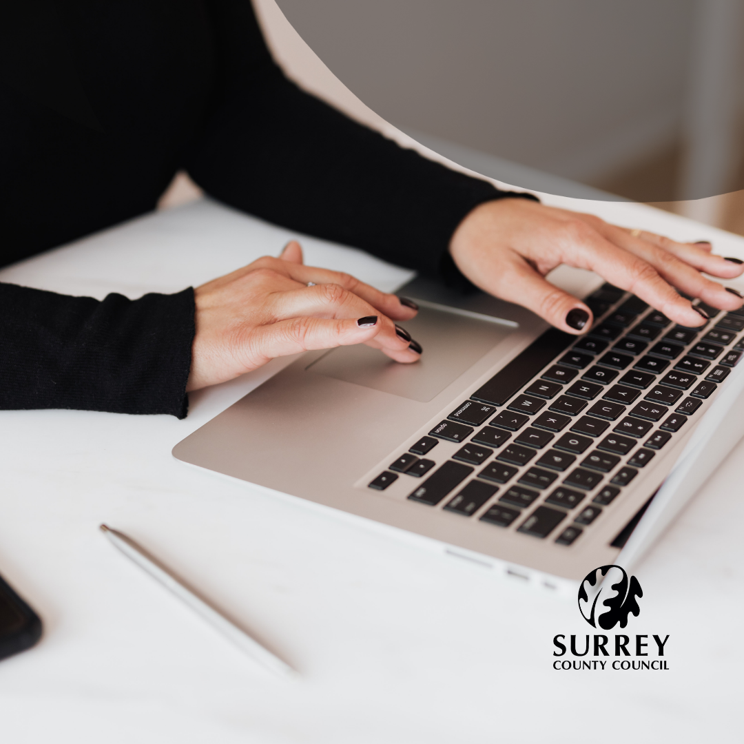 An image of a person with painted nails using a laptop computer.