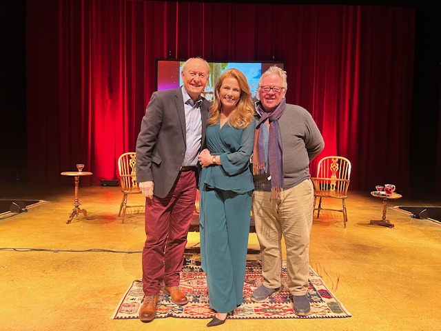 photo of two men and a woman on a stage