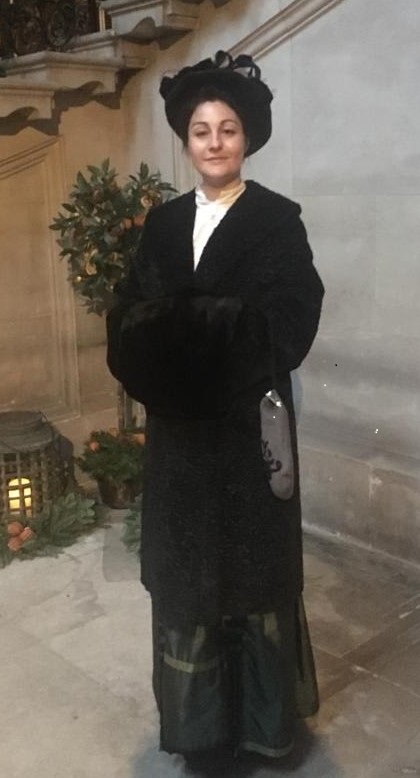 Victorian lady dressed in velvet coat, hat and skirt